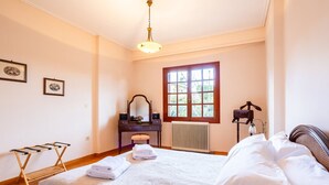 A hotel room with a bed, a dresser, a mirror, a radiator, and a window. - Artemida Beachside Escape w BBQ Parking (Spata-Artemida)