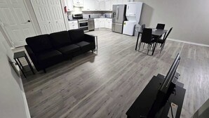 A modern apartment with a living area, dining space, and kitchen. - Private Apartment in Southbury 103 (Southbury)
