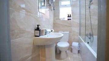 Shower, hair dryer, towels, shampoo