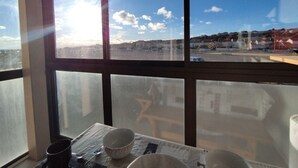 A room with a large window overlooking a cityscape.