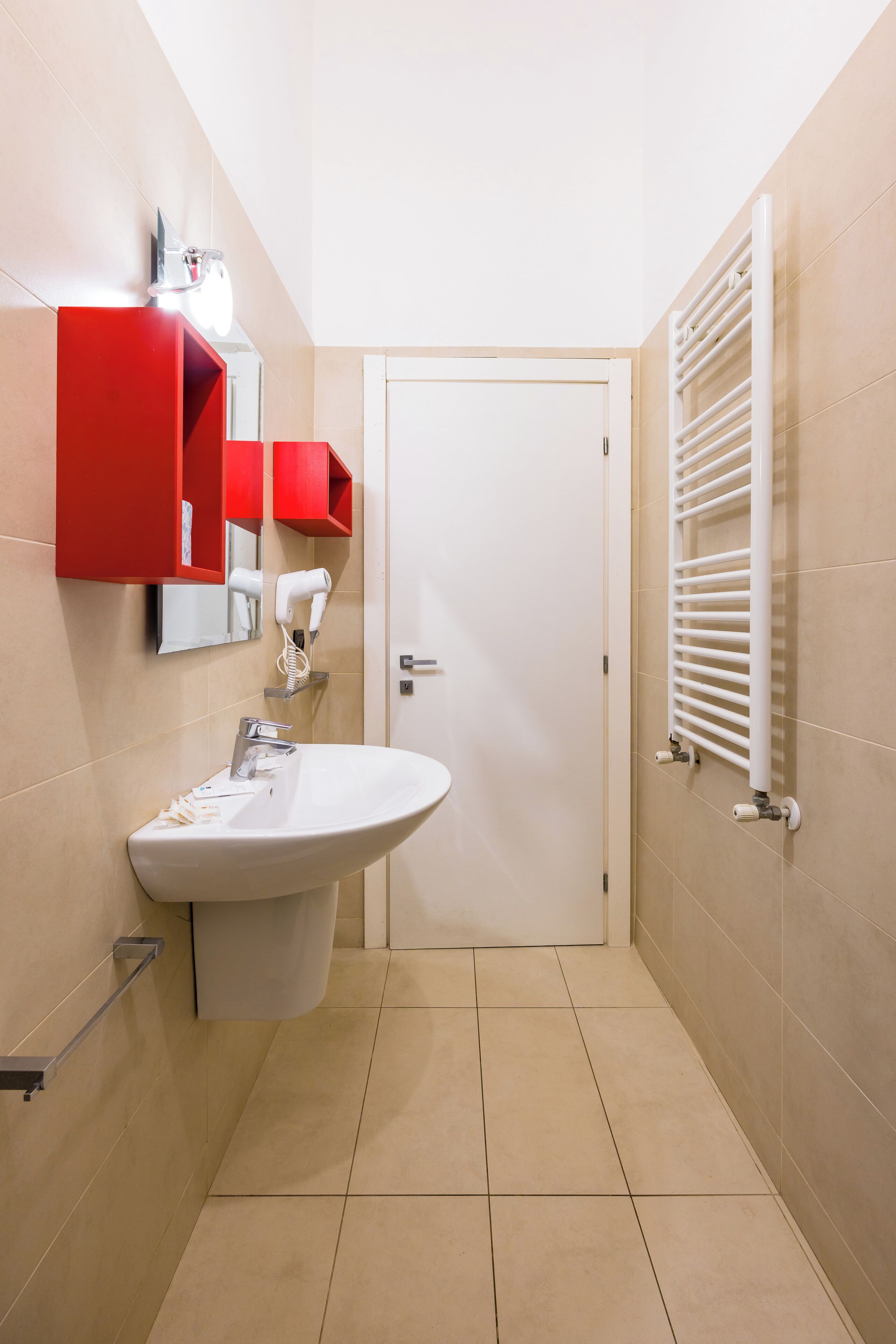 A bathroom with a white sink, a red medicine cabinet, and a white towel rack.