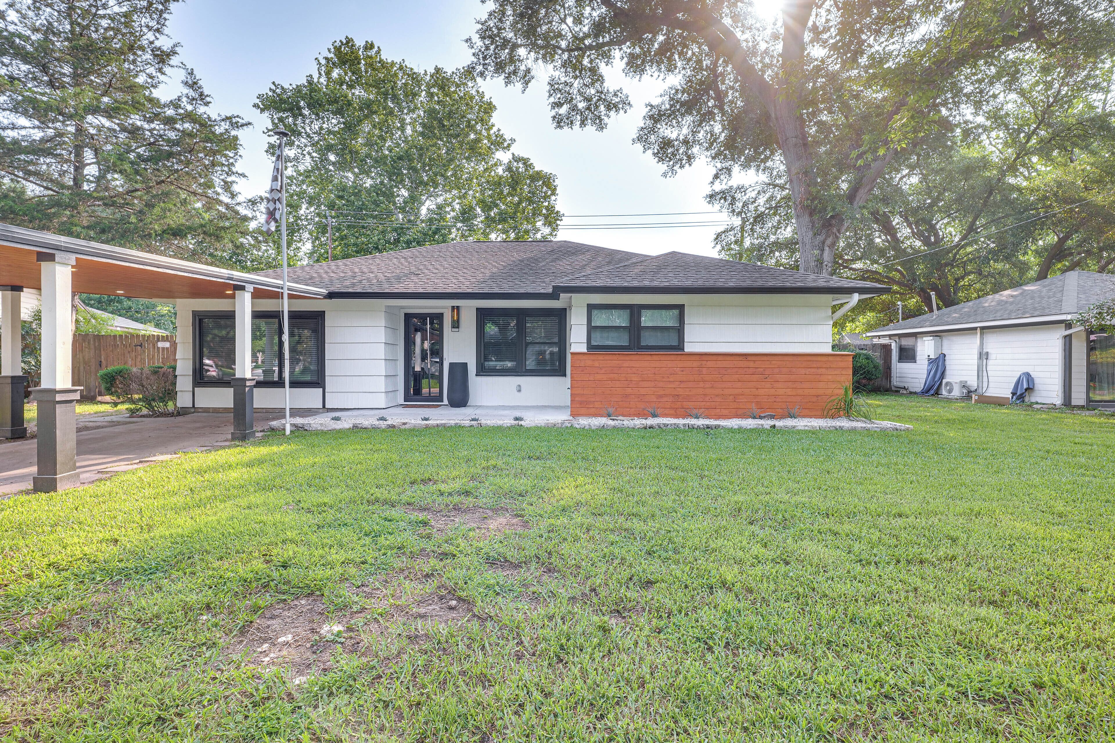 A single-story house with a front porch, a garage, and a well-maintained lawn.