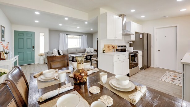 A modern kitchen with white cabinets, a built-in oven, and a refrigerator. - Mtn-view Home w/ Hot Tub: 8 Mi to Joshua Tree! (Joshua Tree)