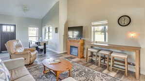 A spacious living room with a fireplace, a television, and a dining area. - Golf Course Views: Oakland City Retreat (Oakland City)