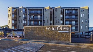 A multi-story building with a sign reading 'Wild Olive.'