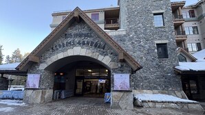 A stone building with a large entrance, a sign for 'Northstar', and a snow-covered ground. - Timber Creek 309 1 Bedroom Condo (Truckee)
