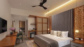 A modern hotel room with a bed, desk, chair, and a ceiling fan.