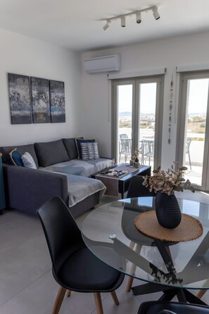 Two Bedroom Deluxe Apartment with Ocean View | Living area | Flat-screen TV