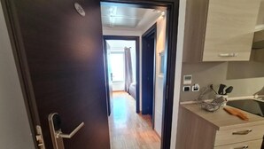 A modern kitchen with wooden cabinets and a countertop. - baja delle sirene (Taranto)
