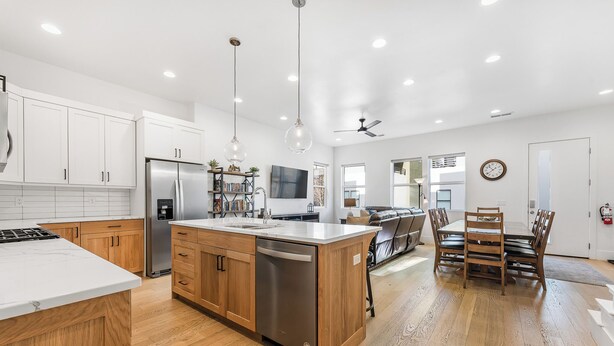 A modern kitchen with white cabinets, a stainless steel refrigerator, and a dishwasher. - Villa #13 at Bloomington Country Club: Pool, Golf, Restaurant (St. George)
