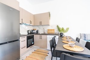 A modern kitchen with a built-in oven, a dishwasher, and a refrigerator.
