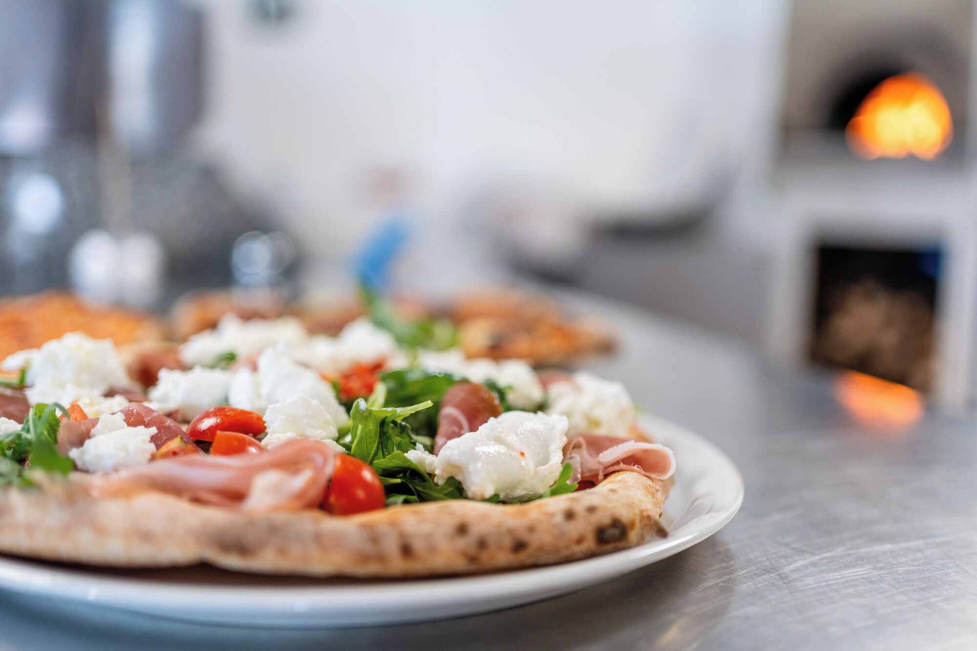 Pizzalautanen, jossa on päällä erilaisia täytteitä.