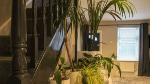 A staircase with a handrail and a potted plant on the landing. - The Cozy Nook -  an annex that sleeps 2 guests  in 1 bedroom (Chester)