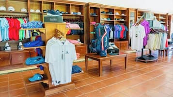 A clothing store with various apparel and footwear on display.