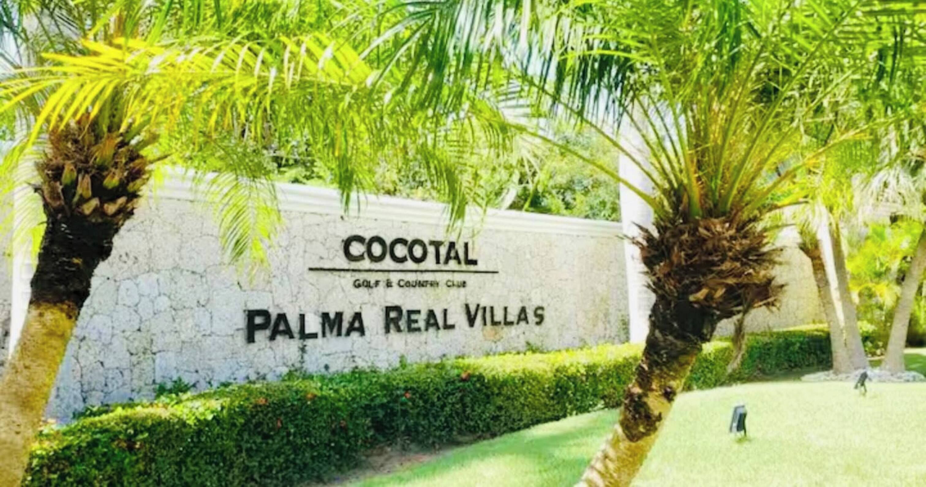 A sign for 'Cocotal Golf & Country Club' with 'Palma Real Villas' written below it.