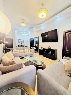 Deluxe Condo, 2 Bedrooms, Golf View | Living area | 43-inch flat-screen TV with digital channels - GLOBALSTAY Cocotal Condo in Punta Cana (Punta Cana)