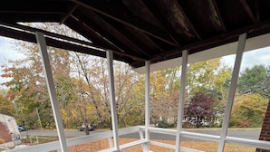 A covered porch with a view of a residential street and autumn foliage. - Hidden Gem Quiet Dead-End St Near All Casino (Montville)