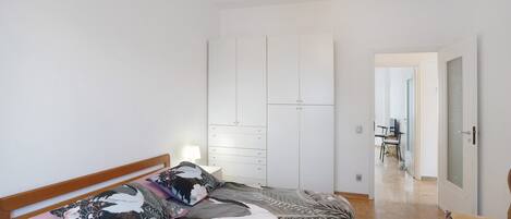Makuuhuoneessa on sänky, vaatekaappi, tuoli ja taustalla työpöytä.
