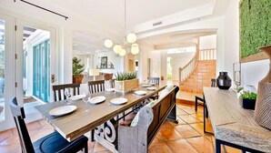 A spacious dining area with a long wooden table set for six, surrounded by chairs. - Last Minute Deals/A/C/Hot Tub/Great Family Home (La Jolla)