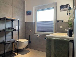 Shower, hair dryer, towels, toilet paper