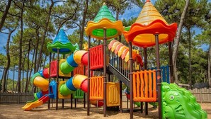 Ein Spielplatz mit bunten Rutschen und Klettergerüsten.