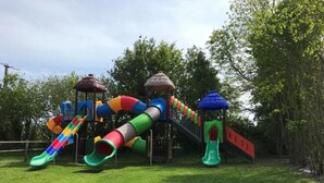 A playground with multiple slides and climbing structures.