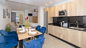 A modern kitchen with wooden cabinets, a black countertop, and stainless steel appliances.