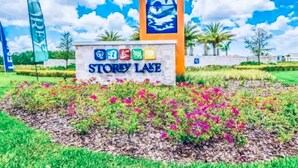 A sign for Storey Lake with a tropical mural and colorful flowers. - 3141-104 Resort Lake View Disney Universal Orlando (Kissimmee)