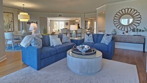A spacious living room with two sofas, a coffee table, and a dining area in the background. - 3rd Floor Villa w/ Ocean Views & Amenities (Hilton Head Island)