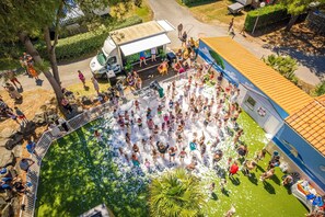 A group of people gathered around a water feature in an outdoor setting.