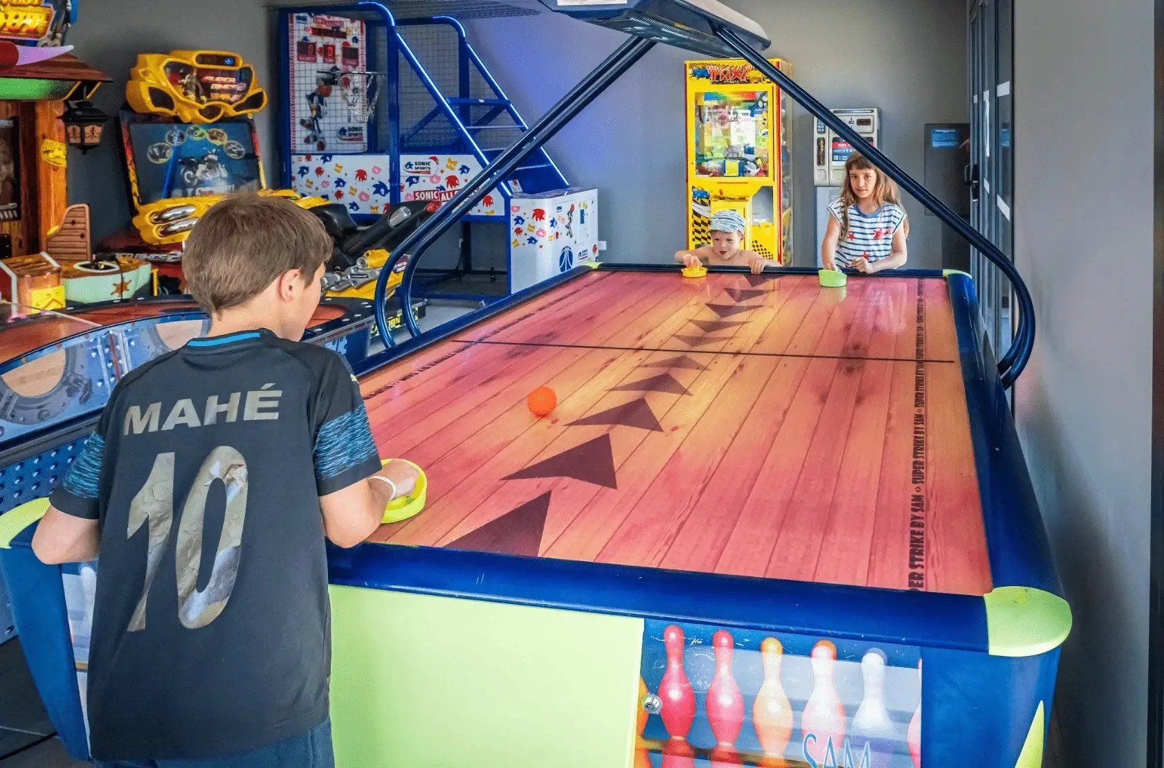 A bowling alley with a wooden floor and a bowling lane.