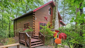A log cabin with a wooden deck, a red star decoration, and a stone chimney. - Views for Days-Big Game Room-Hot Tub-3 King Beds! (Blue Ridge)