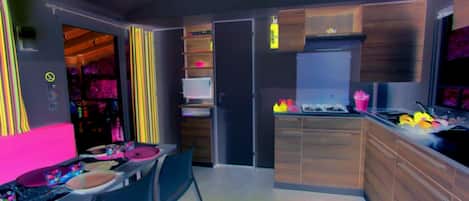 A modern kitchen with a dining area, wooden cabinets, and a built-in oven.
