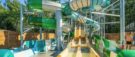A water park with multiple slides and a pool area.