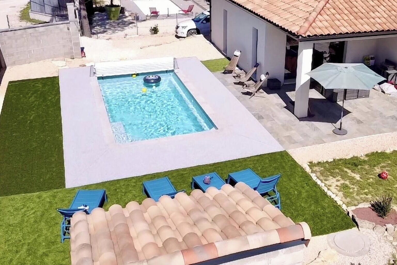 A swimming pool with lounge chairs and a patio area.