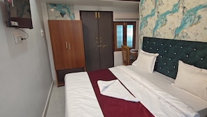 A bedroom with a bed, a wardrobe, and a door. - Hotel Surya Inn  (Prayagraj)