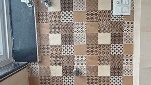 A bathroom with a shower, a sink, and a toilet. - Hotel Surya Inn  (Prayagraj)