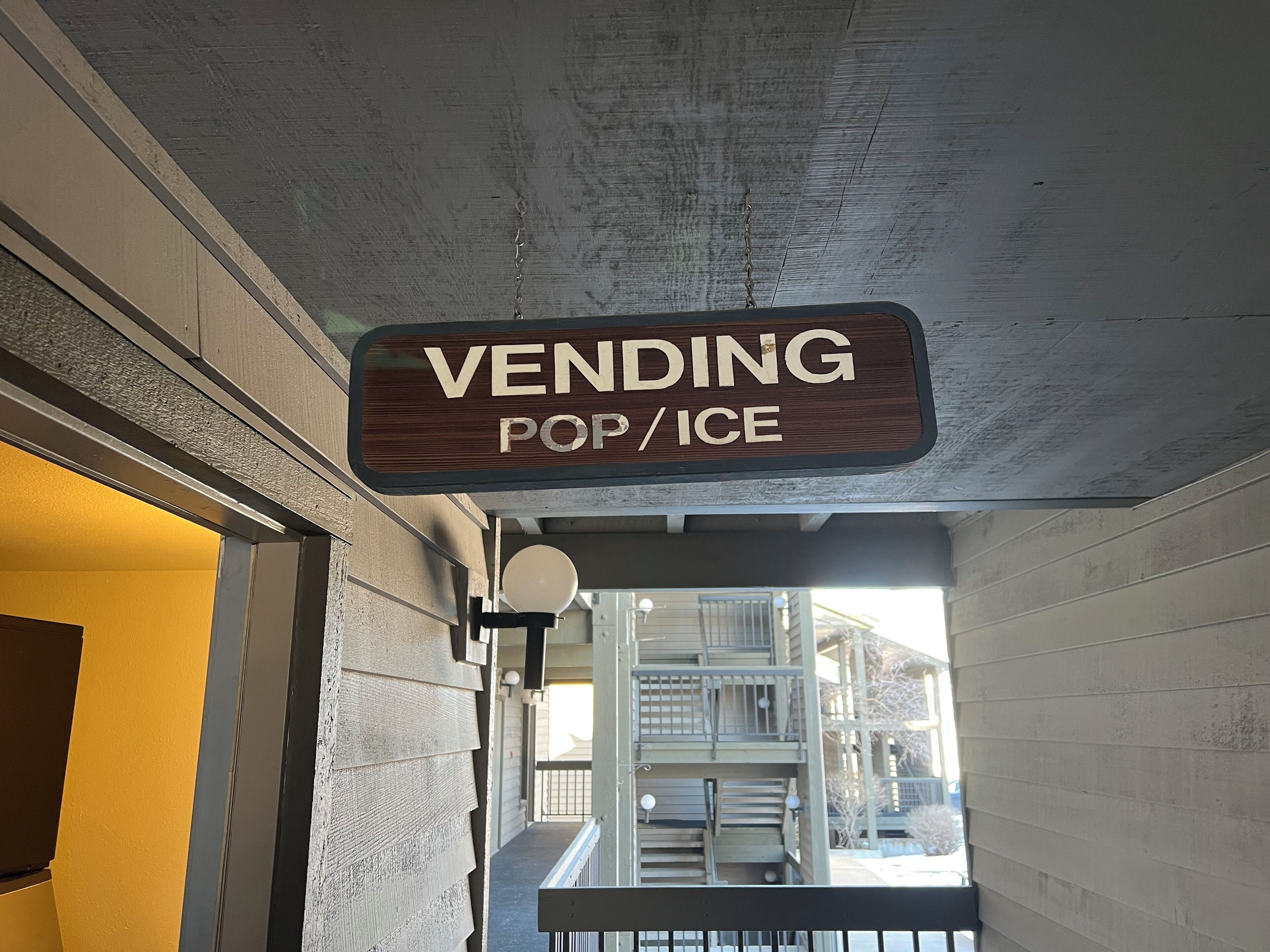 A sign indicating a vending area for pop/ice.