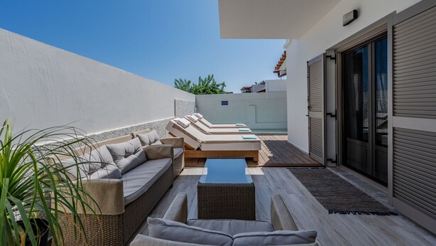 A rooftop terrace with a sofa set, a small table, and a potted plant. - Aloe,pool,near beach & amenities no car needed (Adelianos Kampos)