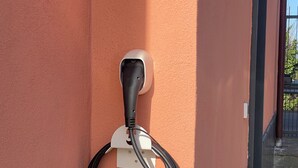 A wall-mounted charging station with a cable connected to a device labeled "wallbox". - Villa in the Green in the hills in Lavagna - 3 Bedrooms, Garden and Private Parking (Lavagna)