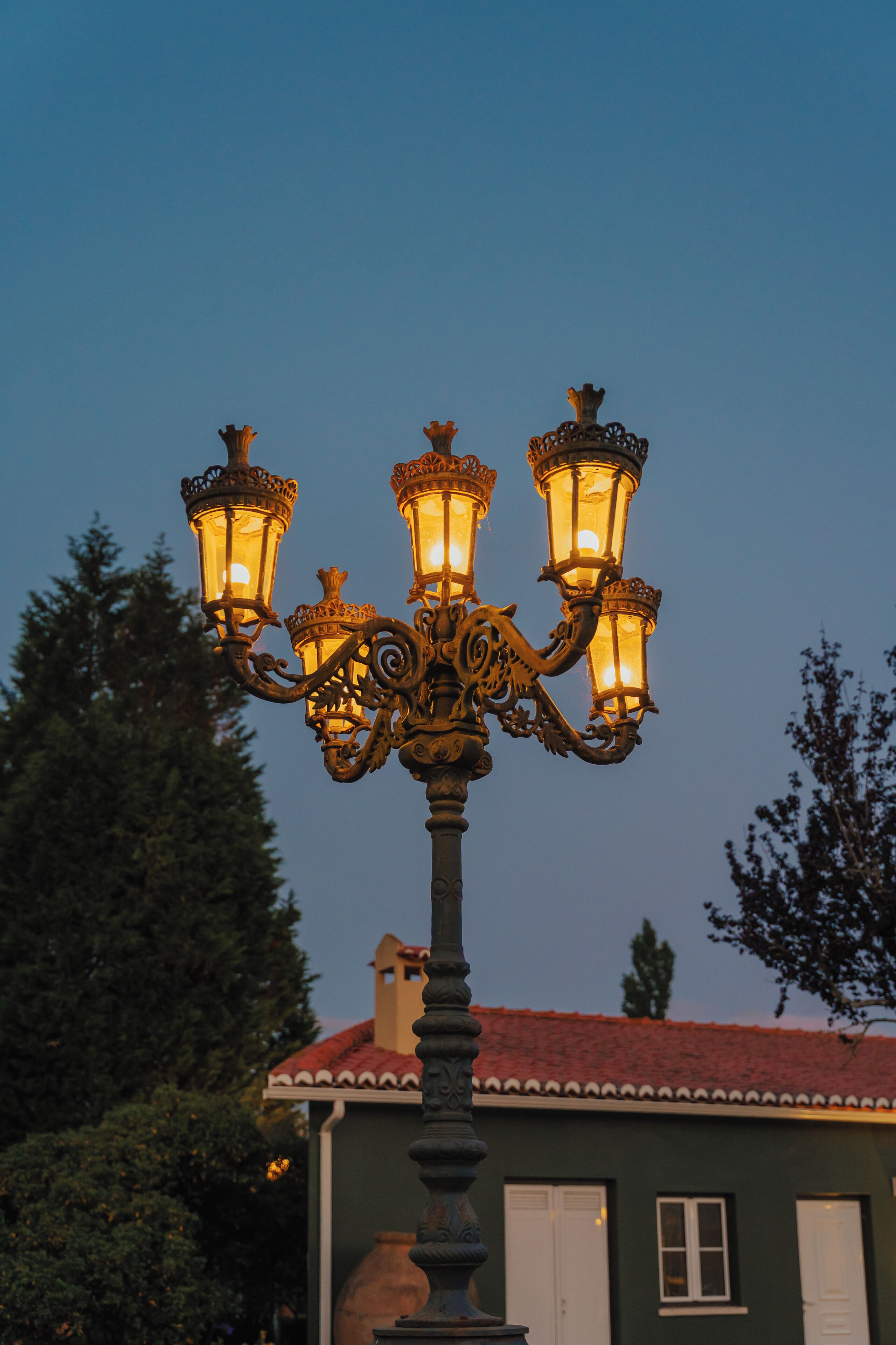 A street lamp with ornate design and multiple lights.