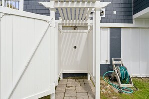 A white wooden gate leading to a covered entryway with a stone-paved path. - Coastal Dream Vacation Home at Moody Beach - Sleeps 8 (Wells)