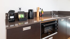 A compact kitchenette with a coffee maker, a kettle, a bottle of olive oil, and a dish soap. - Top Floor, Nest in Mandara Beach - Cote d'Azur (Antibes)