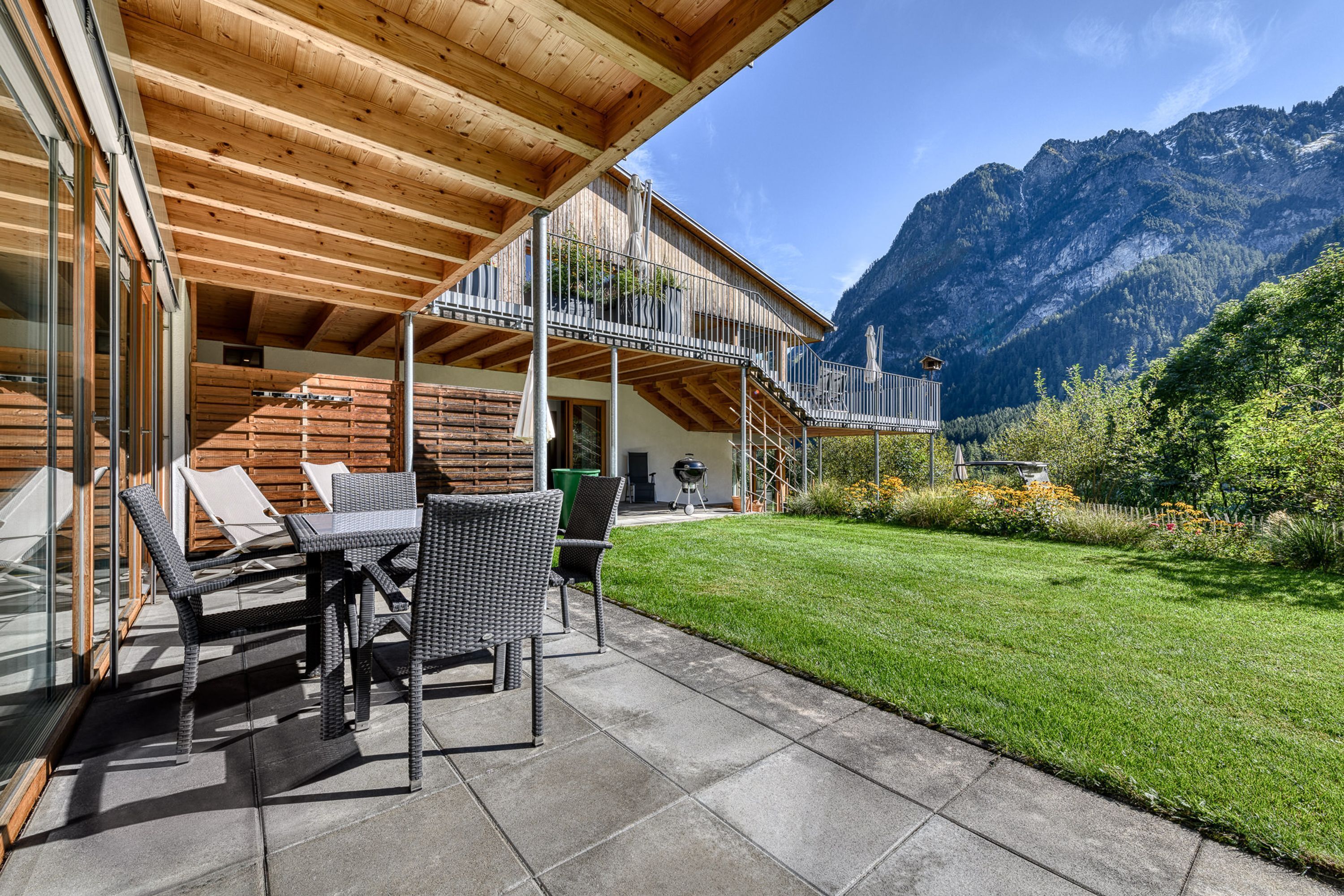 A wooden building with a balcony overlooking a mountain.