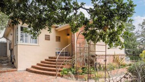A house with a brick staircase leading to a door marked "Z4649." - Carmel Charmer - Close to Downtown w/ Fire Pit! (Carmel-by-the-Sea)