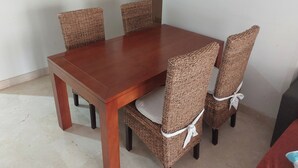 A dining table with four wicker chairs, each with a white ribbon. - 2 Bed Apt-easy Access to Pool-mar Menor Nearby (San Javier)