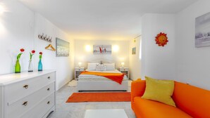 A bedroom with a bed, bedside tables, a dresser, a sofa, and decorative items. - Villa Relax with pool&beachfront by Villas Guide (Bakar)