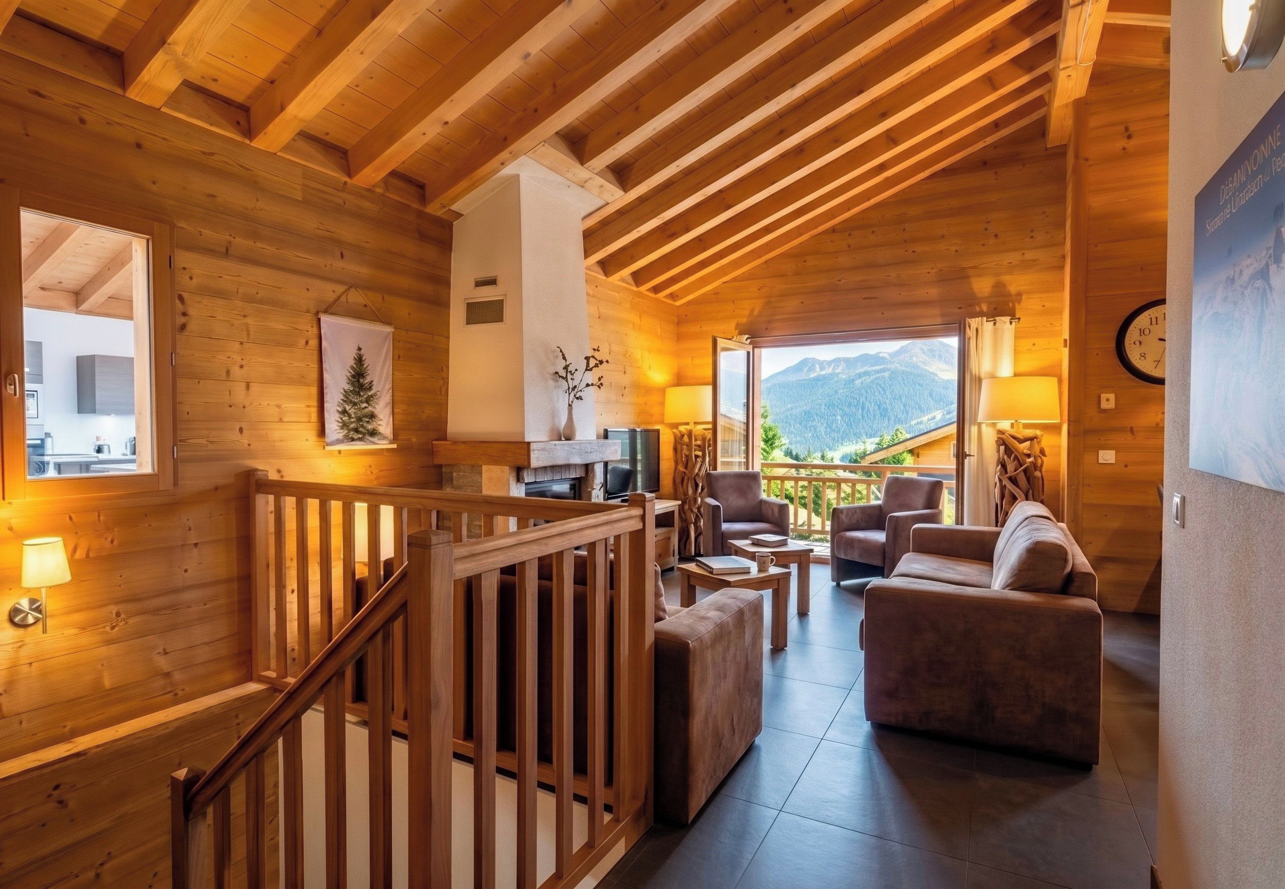 A wooden interior with a staircase, a seating area with a view of mountains, and a clock on the wall.