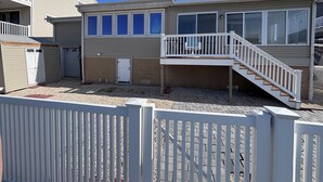 A two-story building with a balcony and a staircase. - Waterfront Family Retreat with Dock, Kayaks & Beach Passes! (Stafford Township)