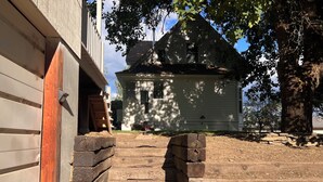 A wooden staircase leading to a house with a gabled roof. - The Hikers Haven  (Thompson Falls)